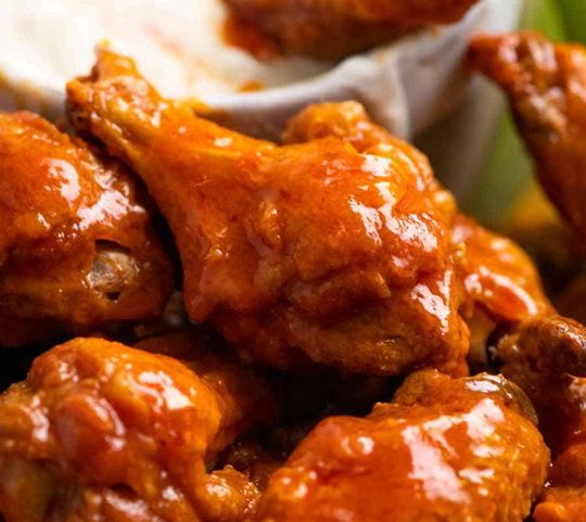 Close up of Buffalo Wings - crispy oven baked wings tossed in Buffalo Sauce