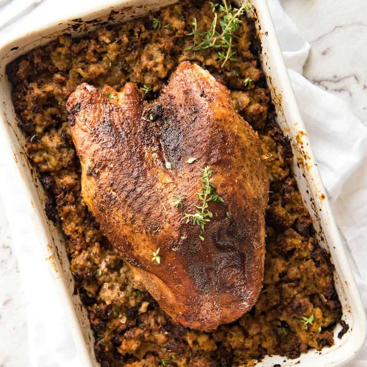 This Cajun dry brined turkey breast is baked in the same roasting pan as the Dressing / Stuffing so it's extra juicy and moist! A chef recipe, this Cajun Baked Turkey Breast with Dressing is easy and spectacular. EPIC ONE PAN COOKING for a Thanksgiving turkey! recipetineats.com