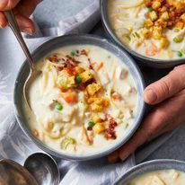 Creamy chicken noodle soup in bowls