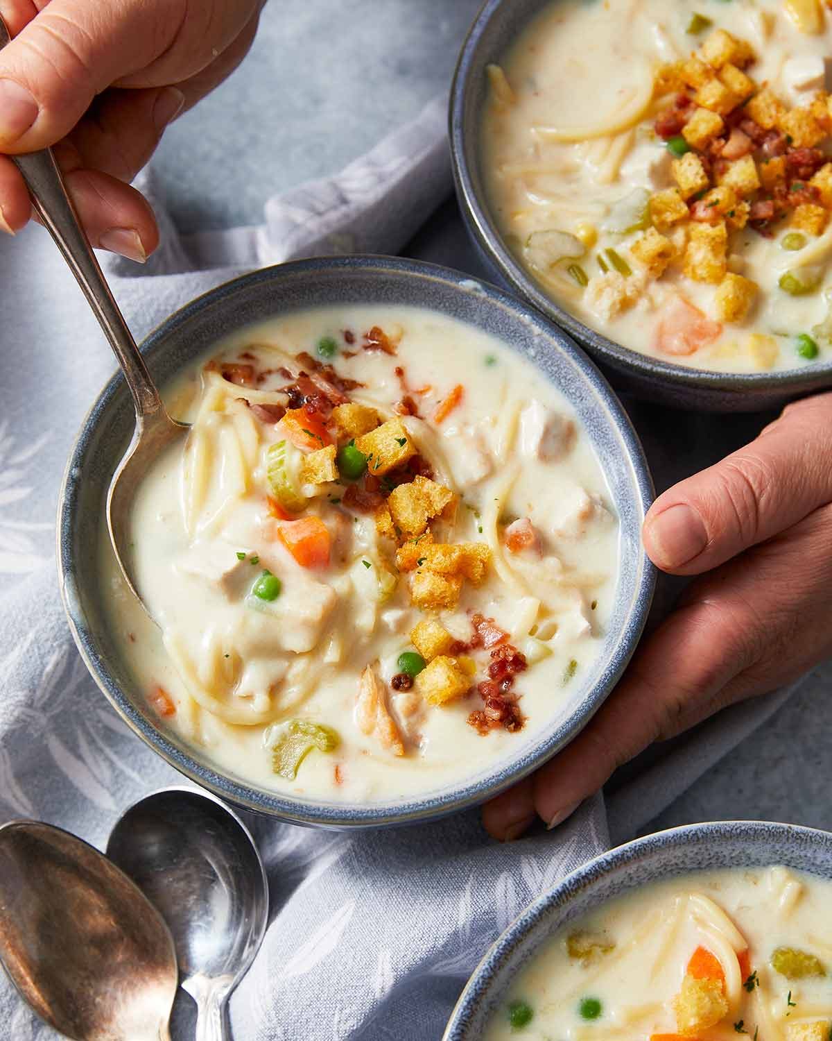 Creamy chicken noodle soup in bowls