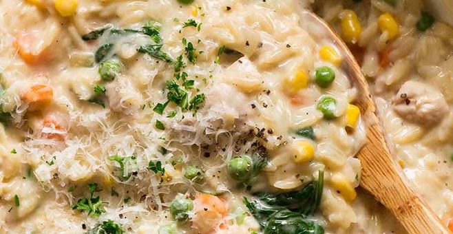 Creamy Chicken Vegetable Orzo in a skillet, fresh off the stove. Quick one pot chicken dinner - 15 minutes!