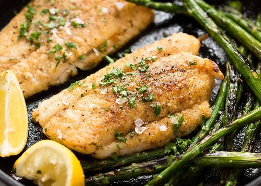 Close up of Crispy Pan Fried Fish in a cast iron skillet, fresh off the stove