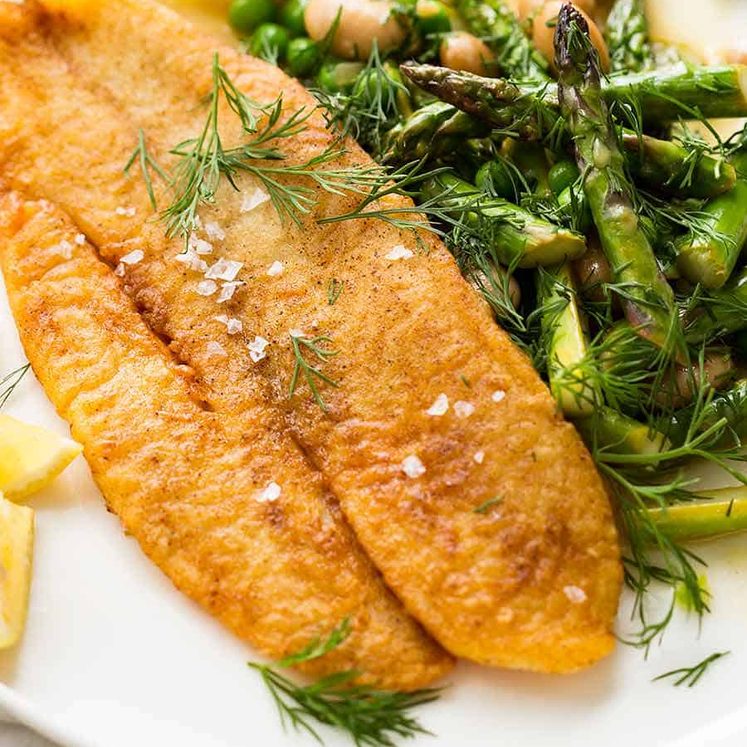 Overhead photo of Crispy Pan Fried Fish with a side of asparagus and beans