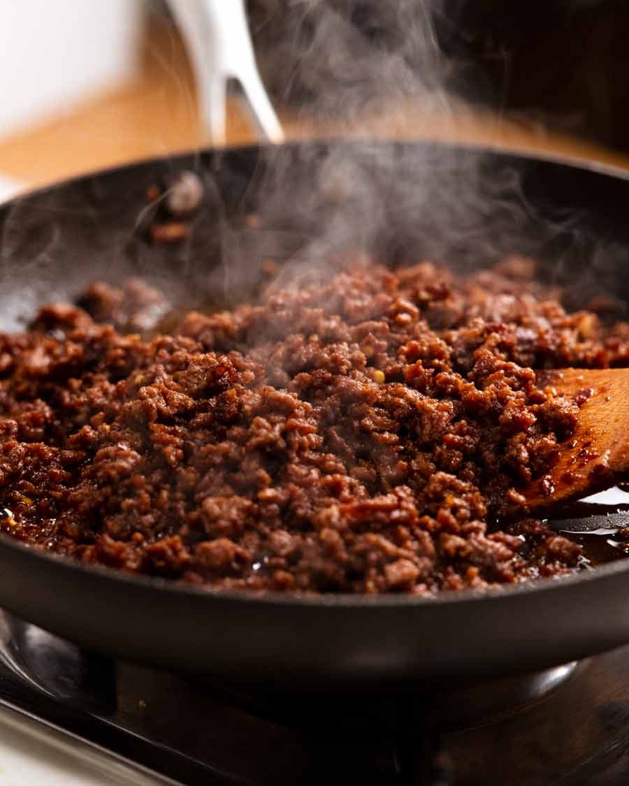 Firecracker beef steaming in a skillet