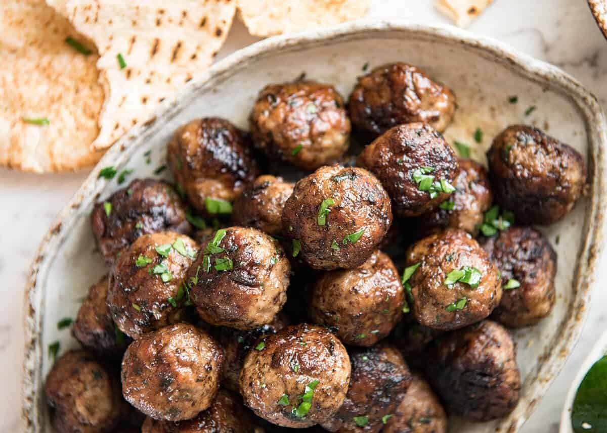 Soft, juicy, beautifully flavoured GREEK MEATBALLS! Serve as an appetiser with tzatziki, main with Greek Salad or make wraps! www.recipetineats.com