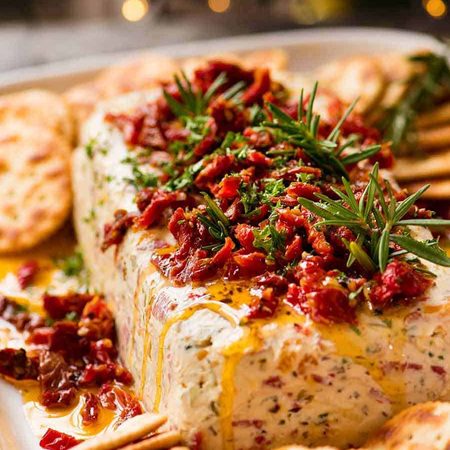 Christmas Appetiser Italian Cheese Log with Christmas tree in background - festive appetizer for the holidays