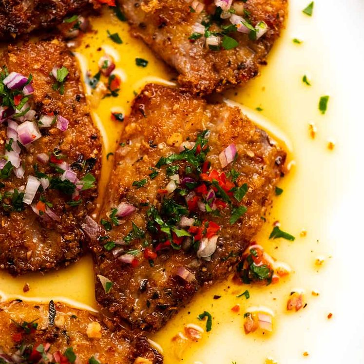 Close up overhead photo of Mediterranean Crusted Sardines on a plate, ready to be served