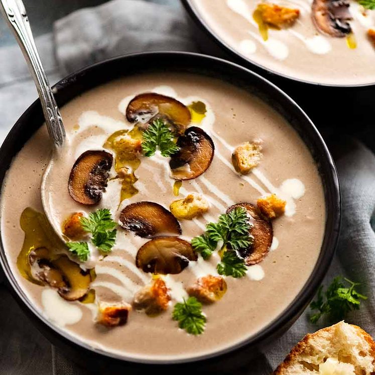 Bowl of Mushroom Soup garnished with golden mushrooms