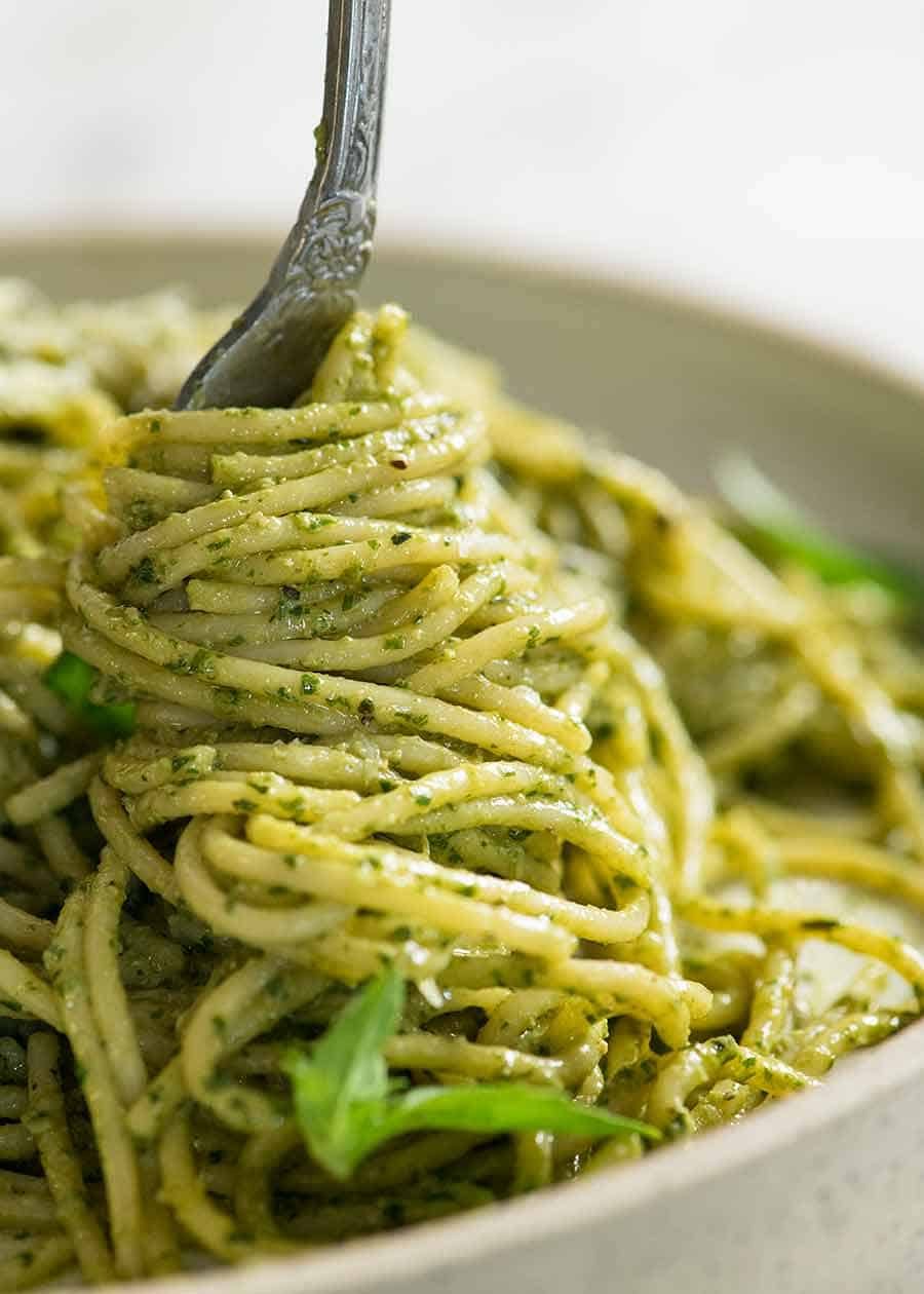 Fork twirling pesto pasta