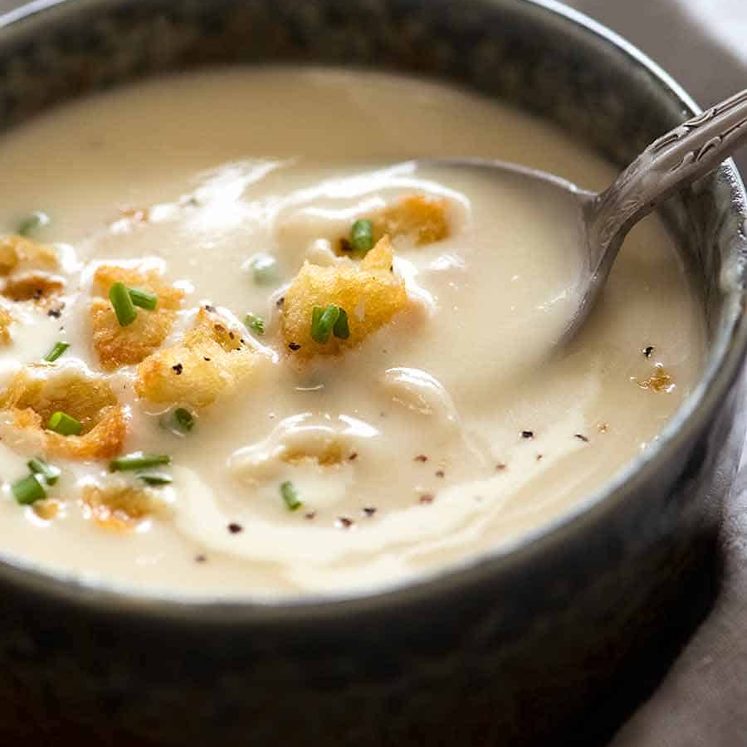 Close up of spoon scooping up thick and creamy Leek and Potato Soup