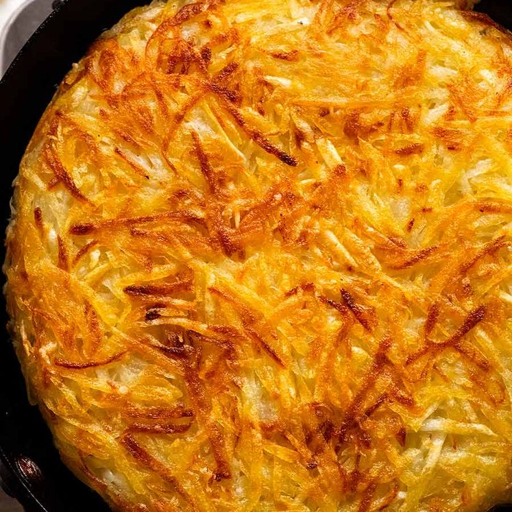 Potato Rosti in a skillet, fresh off the stove