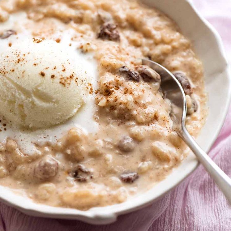 Creamy rice pudding in a bowl with ice cream, ready to be eaten