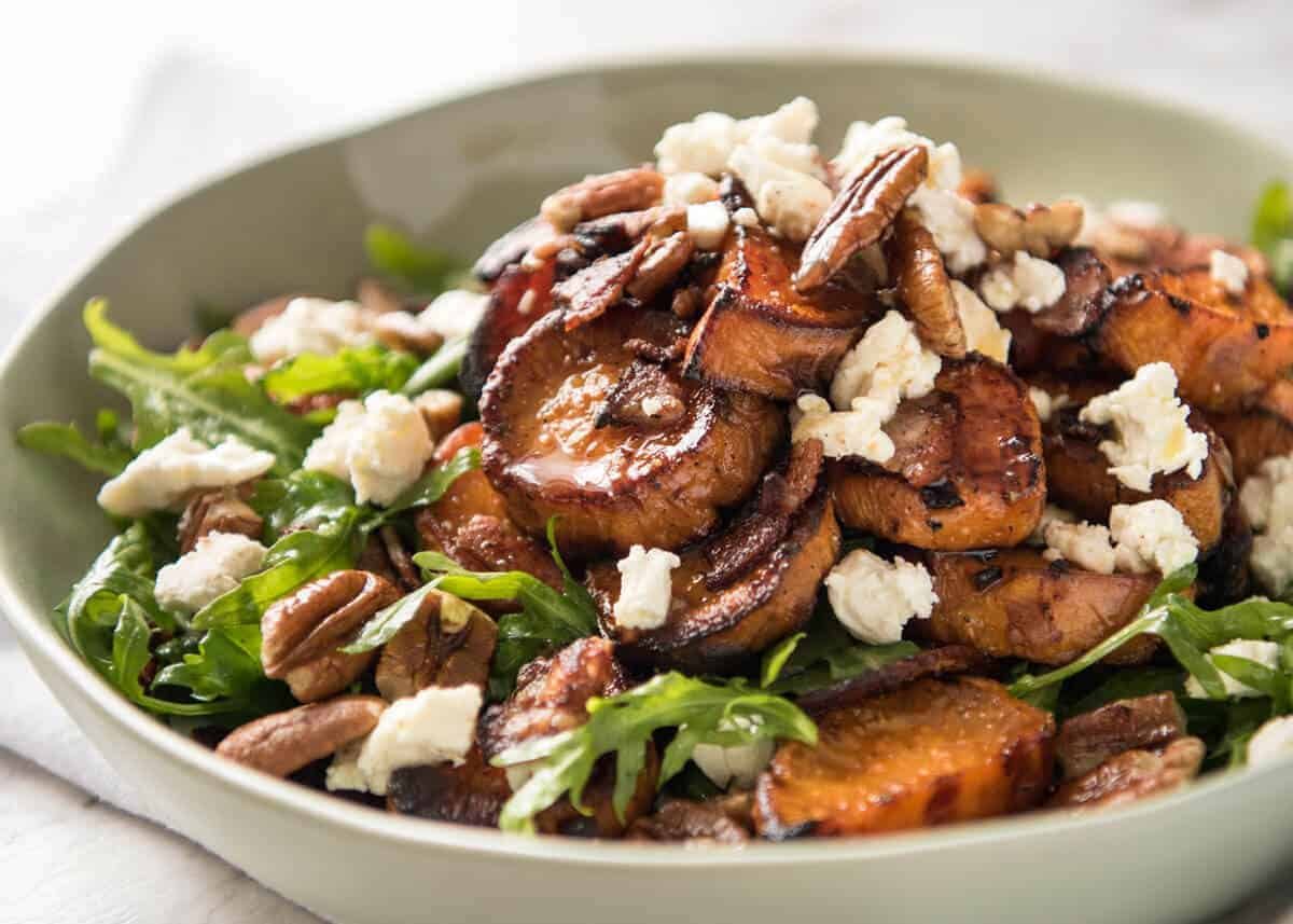 Roasted Sweet Potato Salad - with arugula/rocket, pecans, goats cheese or feta, a sprinkle of bacon and a beautiful Honey Lemon dressing. www.recipetineats.com