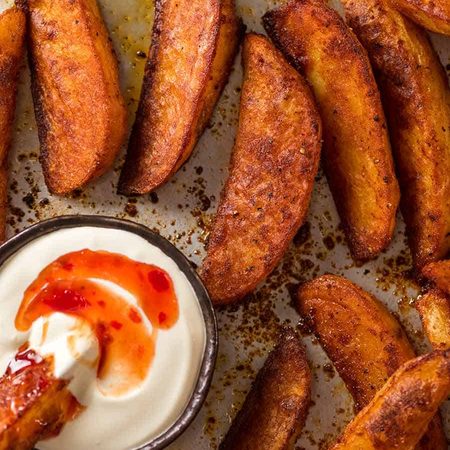 Overhead photo of crunchy baked potato wedges, fresh out of the oven