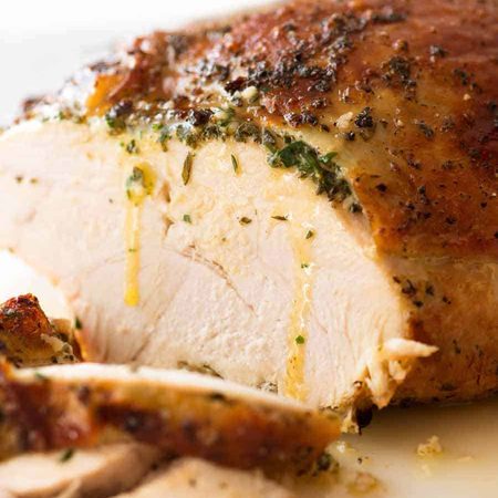 Sliced Garlic Herb Slow Cooker Turkey Breast with butter dripping down