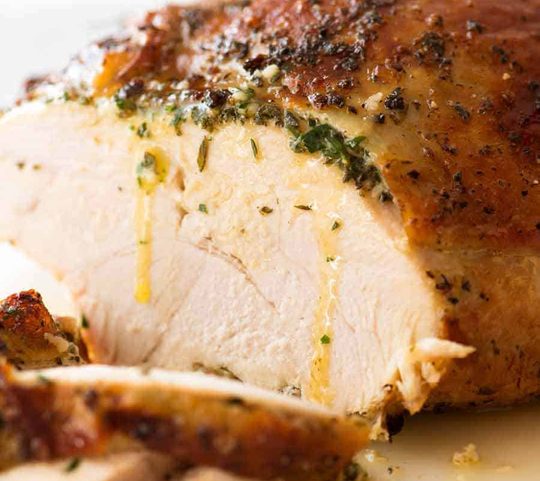 Sliced Garlic Herb Slow Cooker Turkey Breast with butter dripping down