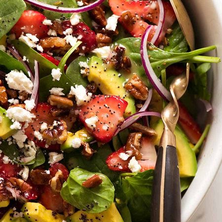 Close up of Strawberry Salad with Avocado in a white bowl, ready to be served