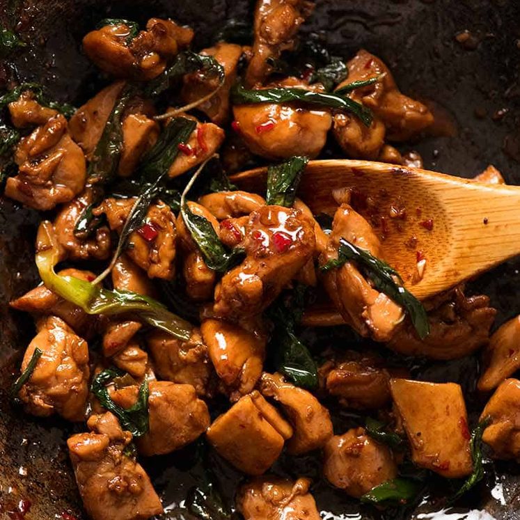 Close up of Thai Basil Chicken in a wok, fresh off the stove ready to be served