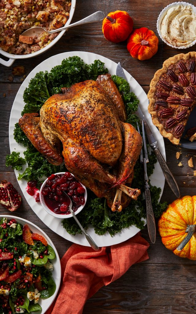 Thanksgiving table spread with turkey and side dishes