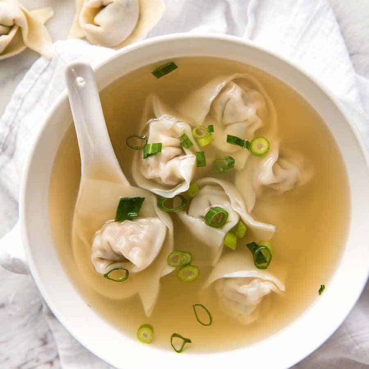 Wonton Soup in a white bowl, ready to be eaten